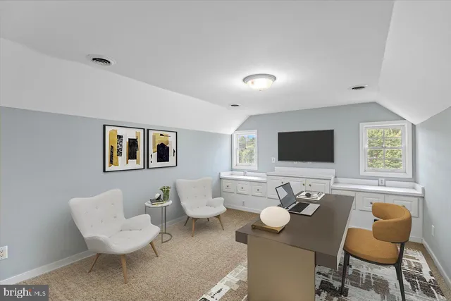 a view of a swimming pool with lawn chairs and plants