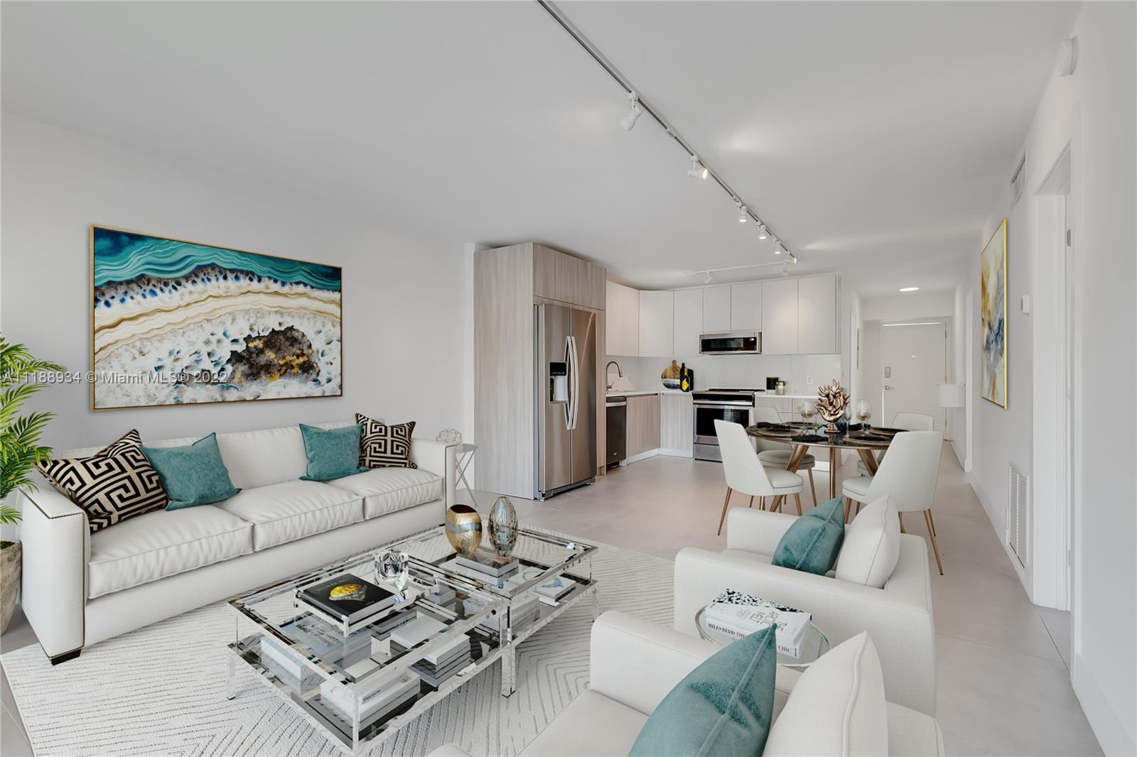 a living room with furniture a rug and kitchen view