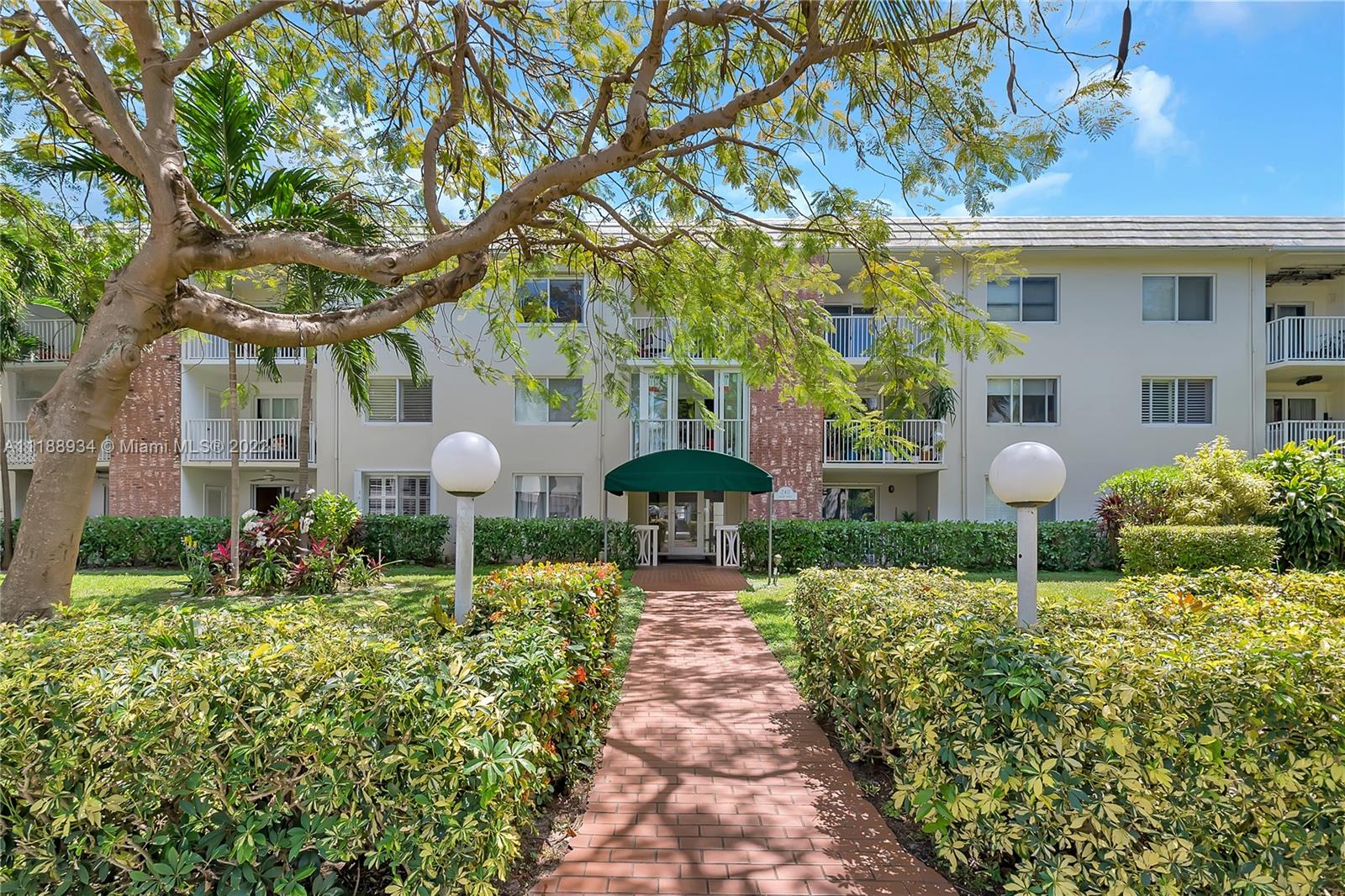 240 Galen Drive, Unit 308 Key Biscayne, FL 33149 - Photo 16 of 22 a front view of a house with a yard and fountain