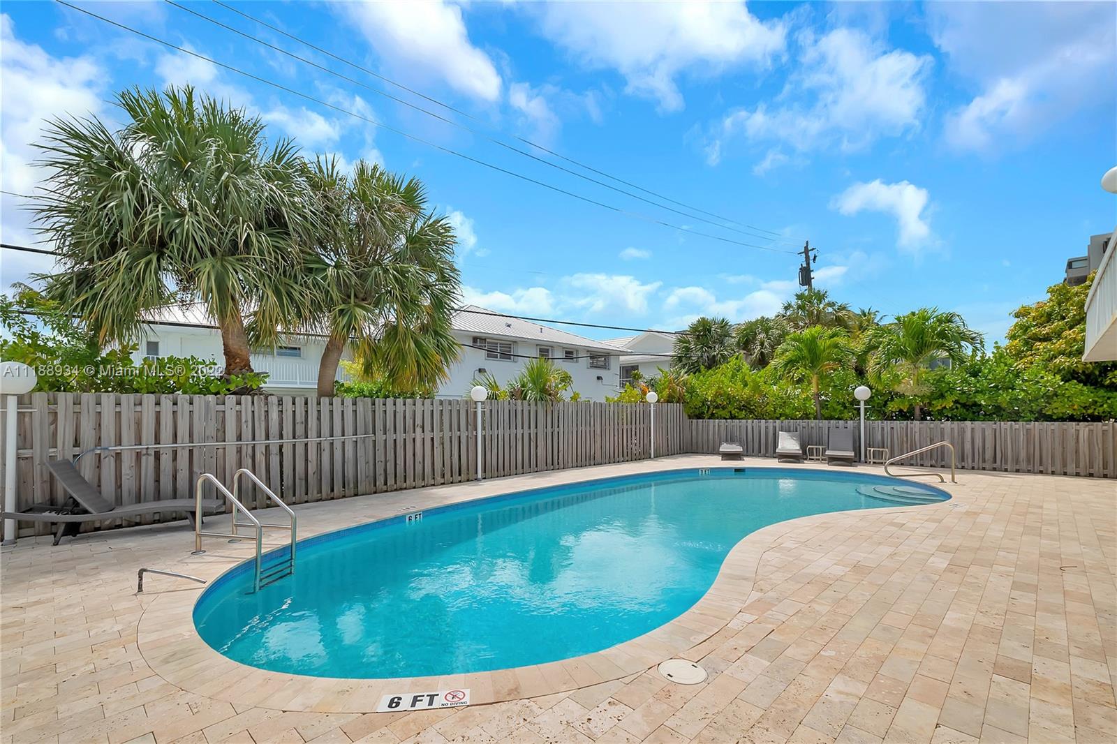 240 Galen Drive, Unit 308 Key Biscayne, FL 33149 - Photo 18 of 22 a view of a backyard with a small swimming pool