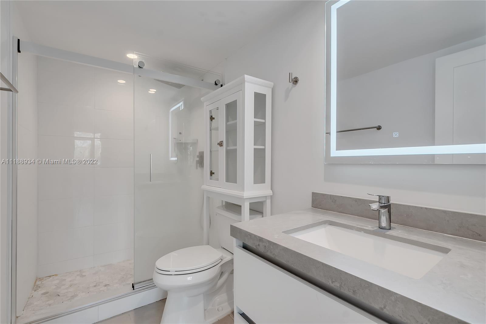 240 Galen Drive, Unit 308 Key Biscayne, FL 33149 - Photo 7 of 22 a bathroom with a granite countertop sink toilet and shower