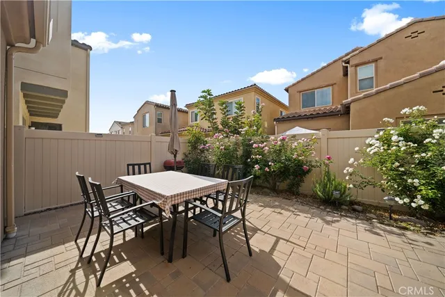 a view of a patio with table and chairs and potted plants