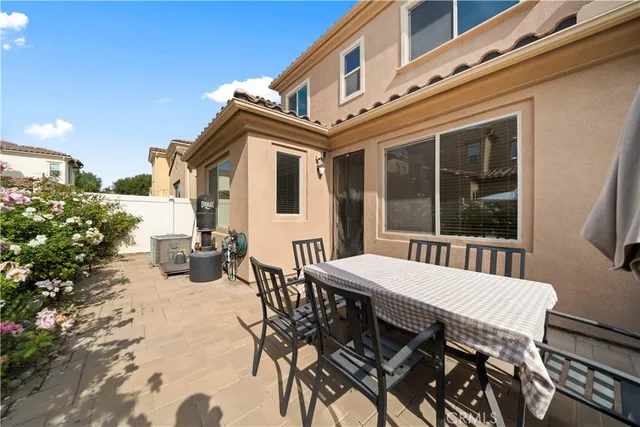 a view of a patio with table and chairs and potted plants