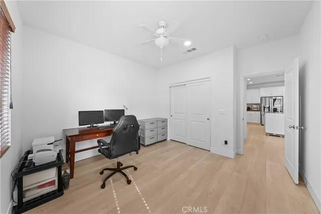 a view of a workspace with furniture and a bedroom