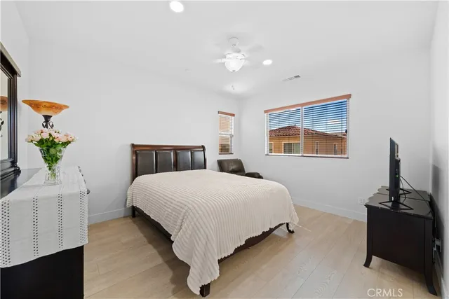 a bedroom with a bed and a potted plant