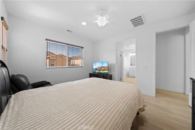 a bedroom with a bed and a painting on the wall