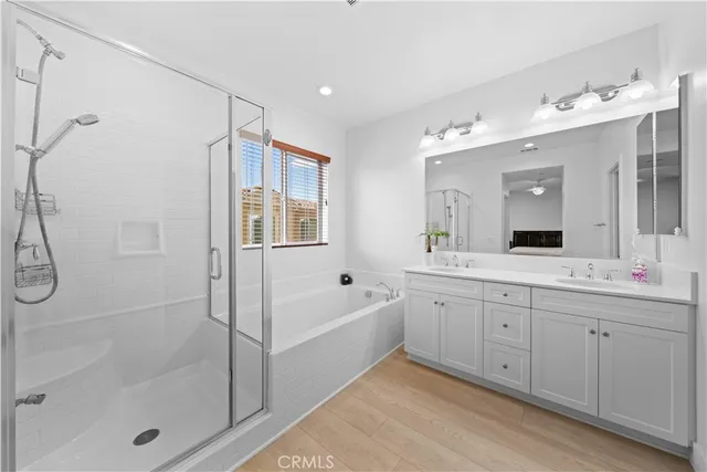 a spacious bathroom with a tub sink shower and mirror