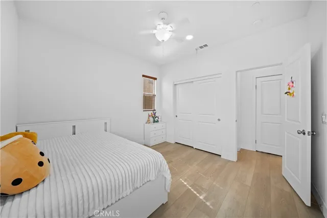 a spacious bedroom with a bed and a chandelier