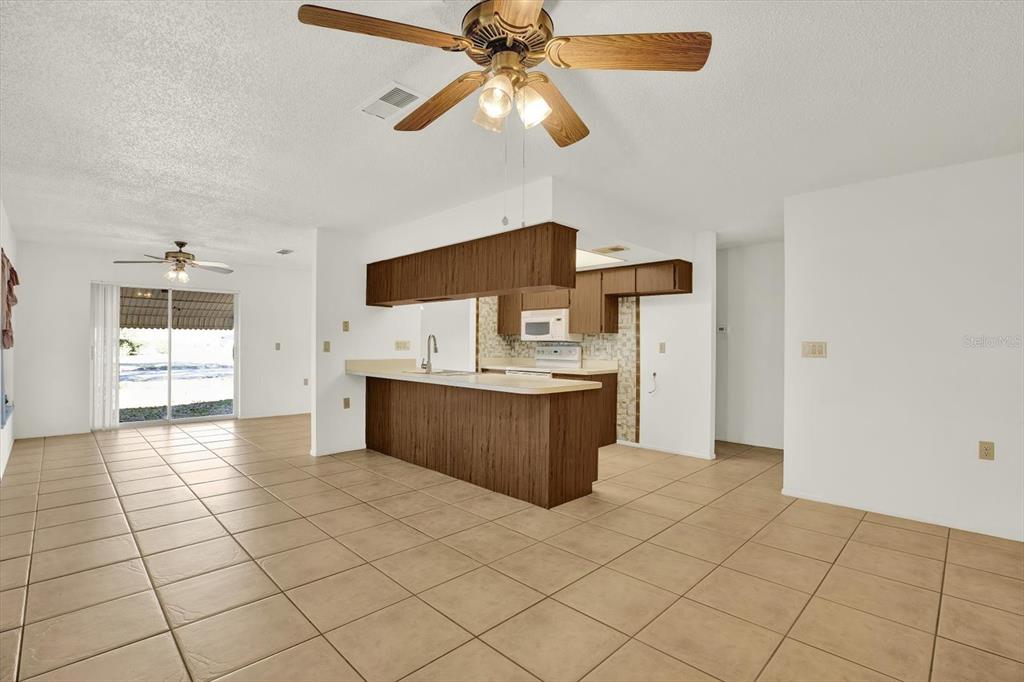 8410 Elgin Drive Port Richey, FL 34668 - Photo 12 of 37 a kitchen with stainless steel appliances a sink and a refrigerator