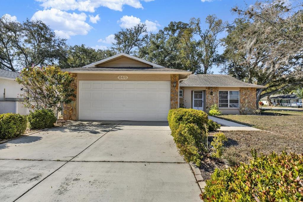 8410 Elgin Drive Port Richey, FL 34668 - Photo 2 of 37 a front view of a house with garden