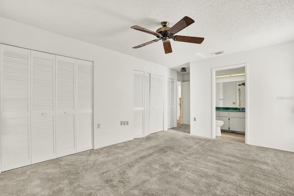 8410 Elgin Drive Port Richey, FL 34668 - Photo 23 of 37 a view of a livingroom with a ceiling fan & entryway