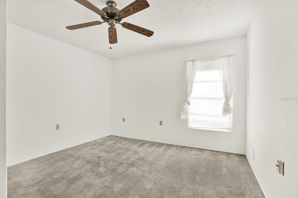 8410 Elgin Drive Port Richey, FL 34668 - Photo 26 of 37 an empty room with a window and a fan