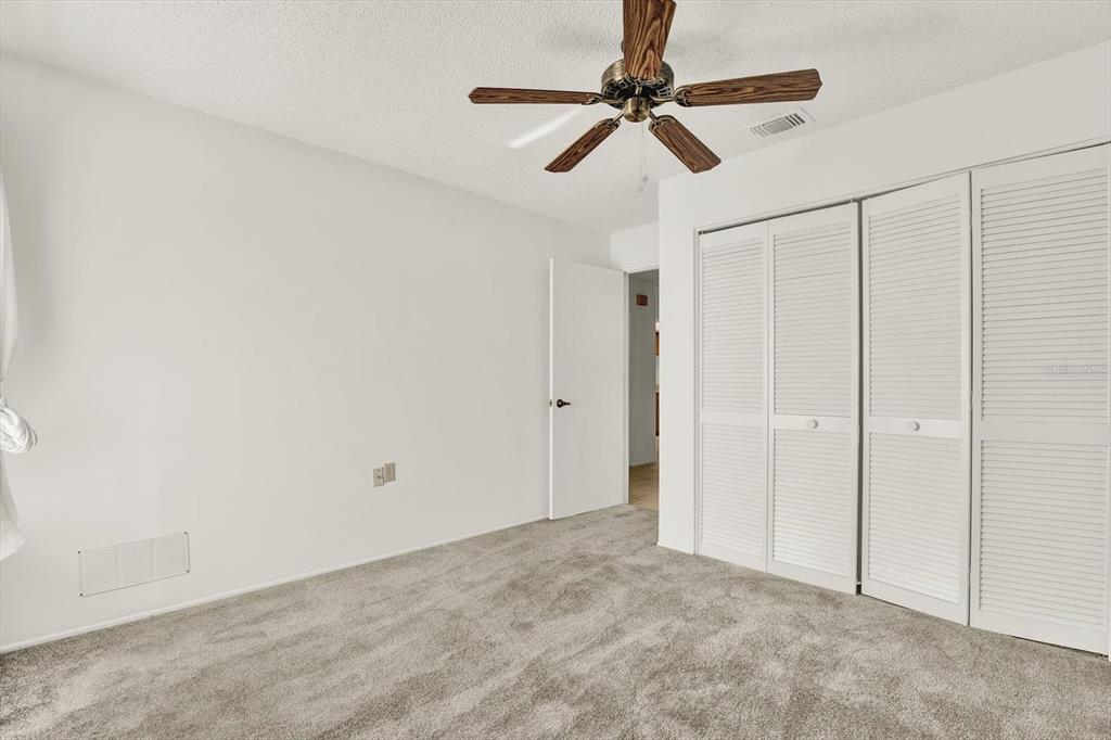 8410 Elgin Drive Port Richey, FL 34668 - Photo 27 of 37 a view of a room with a ceiling fan