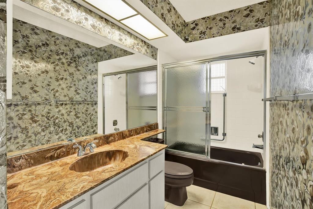 8410 Elgin Drive Port Richey, FL 34668 - Photo 28 of 37 a bathroom with a granite countertop sink a toilet and shower