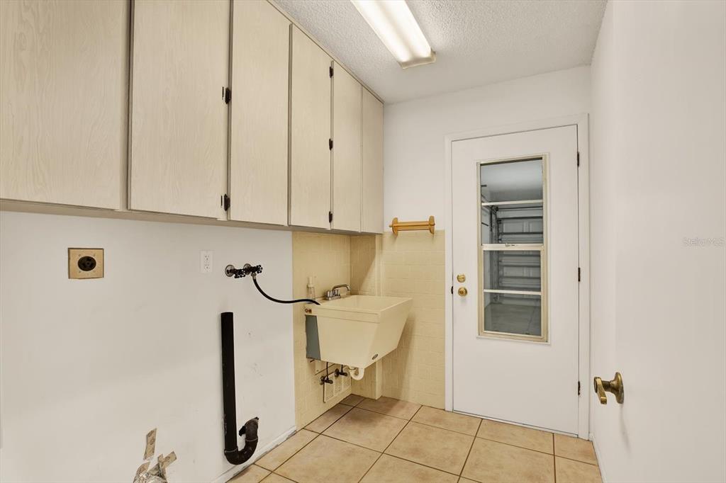 8410 Elgin Drive Port Richey, FL 34668 - Photo 29 of 37 a view of a storage & utility room with a sink