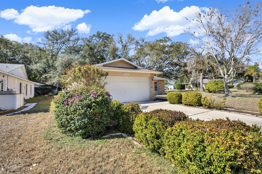 8410 Elgin Drive Port Richey, FL 34668 - Photo 34 of 37 a front view of a house with a yard and garage