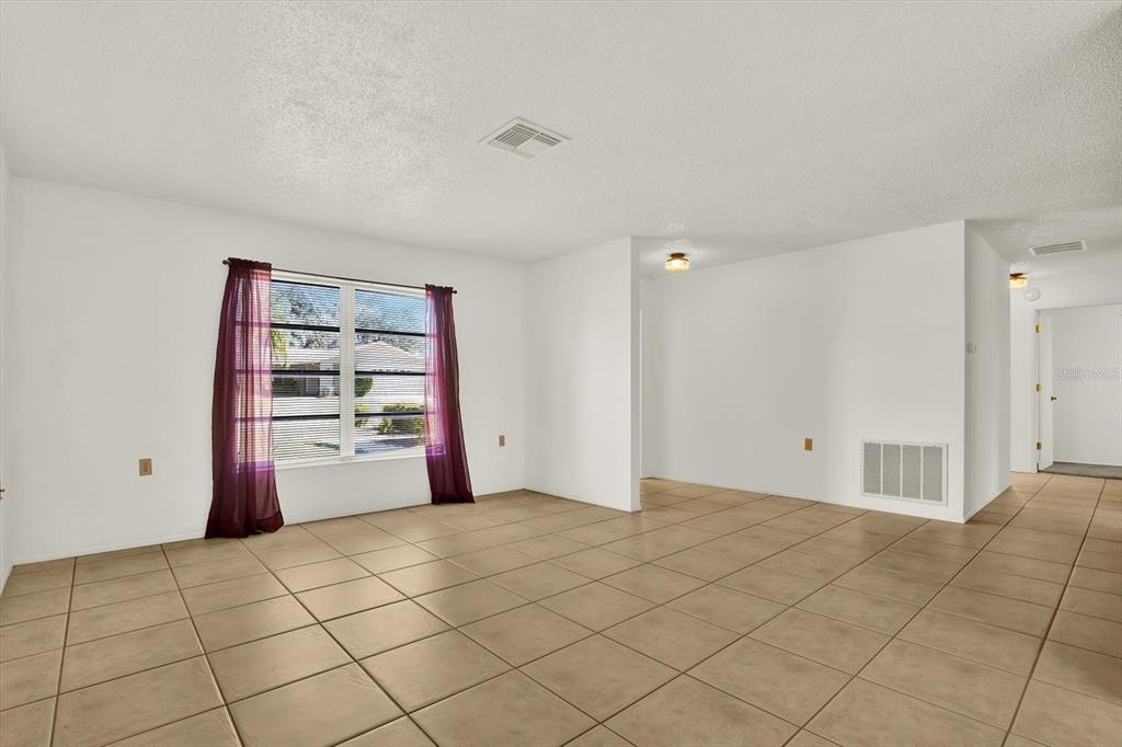 8410 Elgin Drive Port Richey, FL 34668 - Photo 6 of 37 a view of an empty room with a window