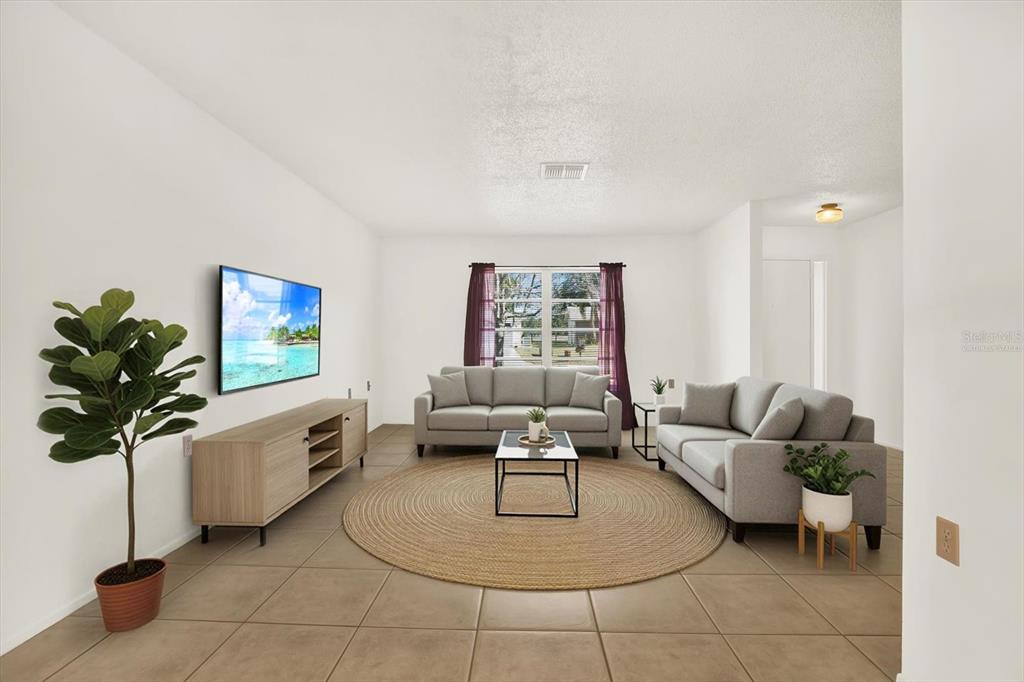 8410 Elgin Drive Port Richey, FL 34668 - Photo 7 of 37 a living room with furniture and a potted plant