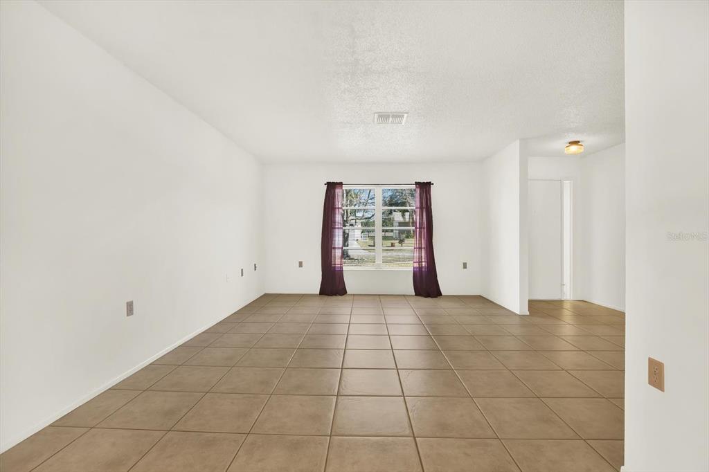 8410 Elgin Drive Port Richey, FL 34668 - Photo 8 of 37 a view of an empty room with a window