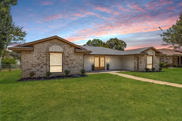 a front view of a house with a garden