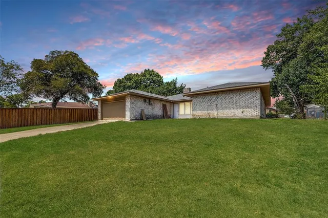 a front view of house with a garden