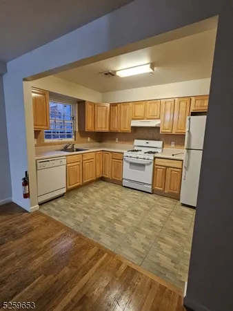 a kitchen with a stove top oven and refrigerator
