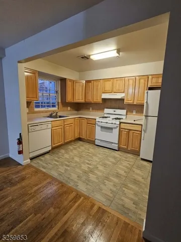 a kitchen with a stove top oven and refrigerator