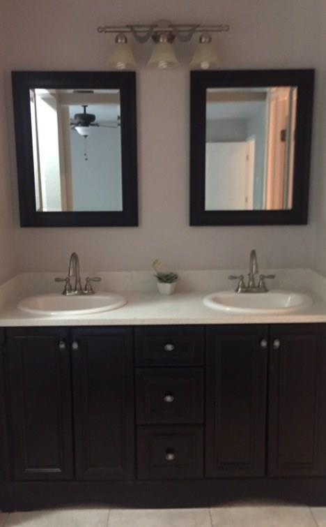 3305 Spaniel Drive Austin, TX 78759 - Photo 10 of 20 A well-appointed bathroom vanity features dual sinks set in clean white countertops.