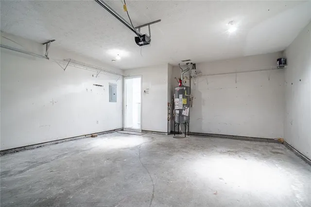 an empty room with ceiling fan and windows