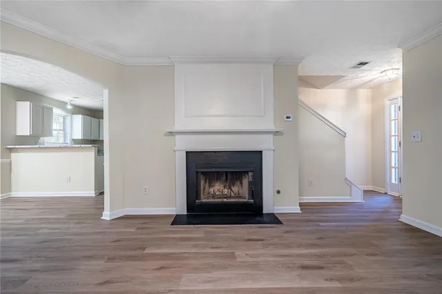 a living room with a fireplace and a wooden floor