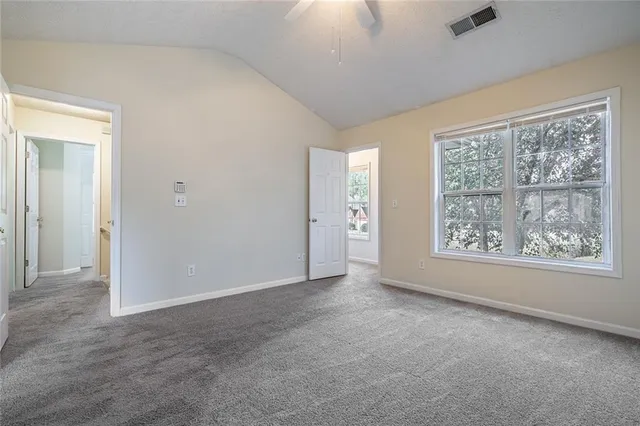 an empty room with windows and closet