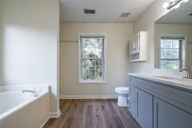 a white bath tub sitting next to a window
