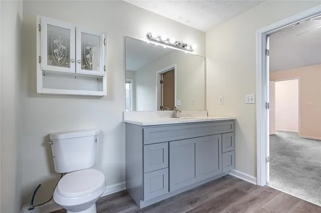 a bathroom with a granite countertop sink a toilet and a bathtub