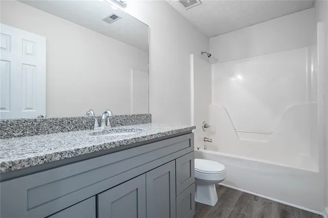 an empty room with closet and wooden door