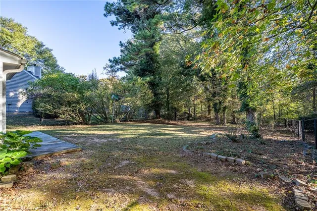 a view of a yard with large trees