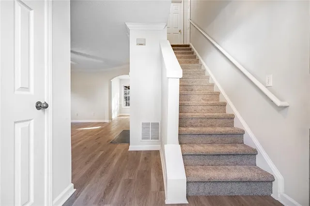 a view of entryway and hall with wooden floor