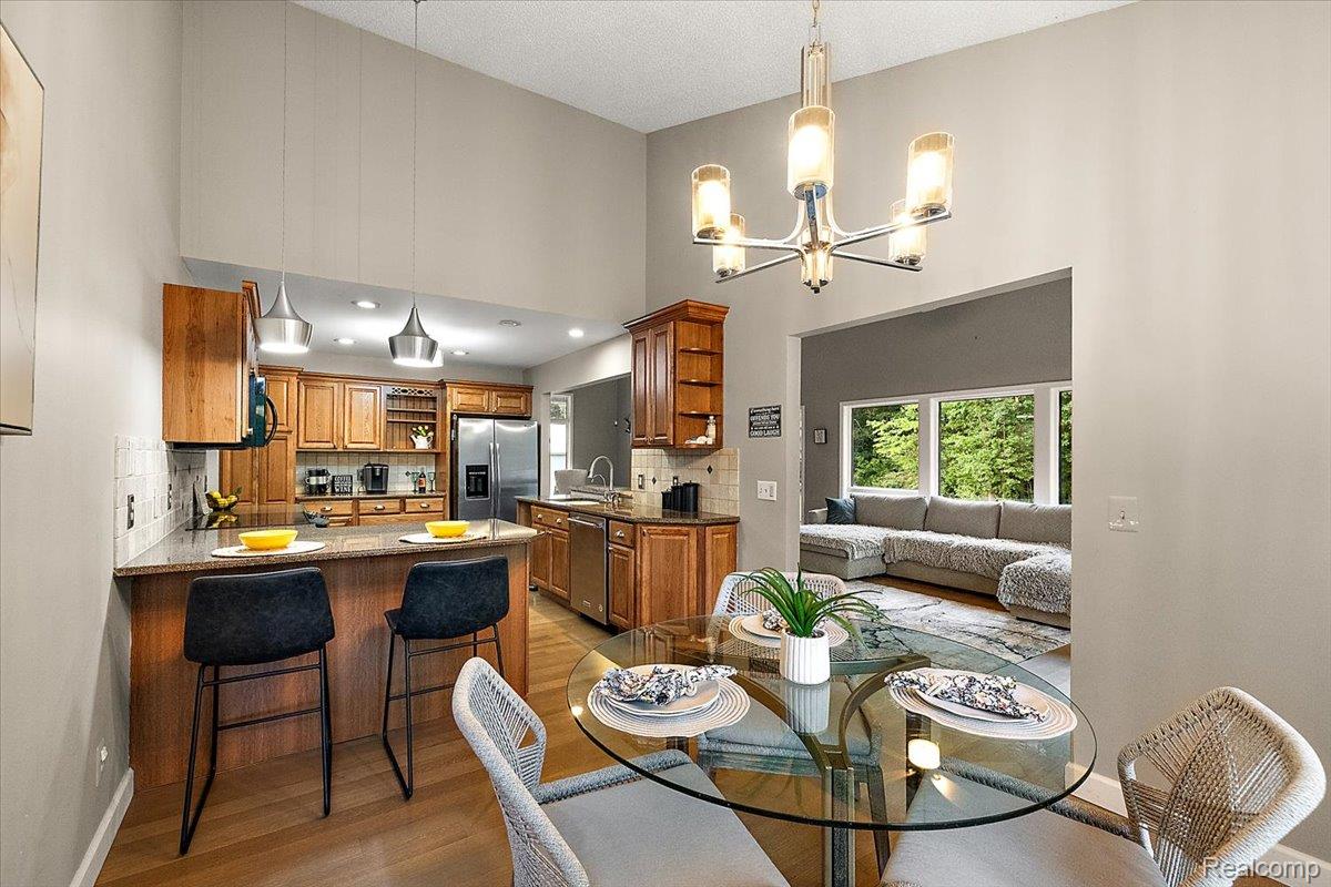 707 West Sutton Road Metamora, MI 48455 - Photo 32 of 84 Kitchen with wood cabinetry, stainless steel appliances, and a breakfast bar