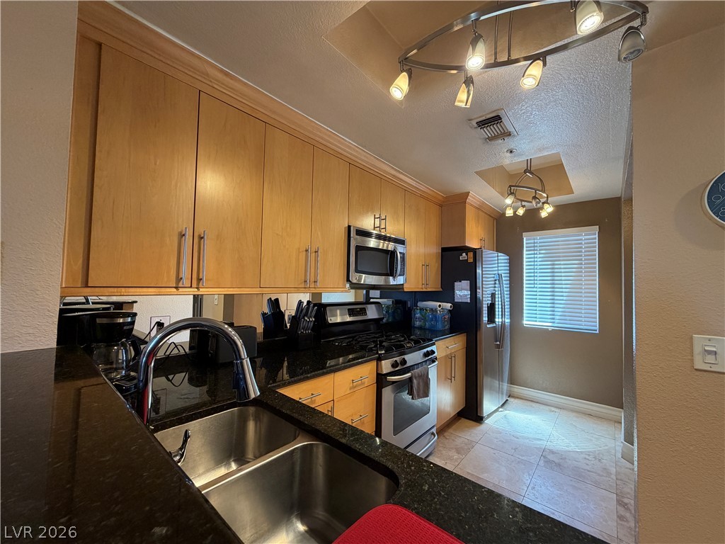 210 East Flamingo Road, Unit 426 Las Vegas, NV 89169 - Photo 3 of 17 Granite counters and stainless steel appliances complete this compact, functional kitchen.