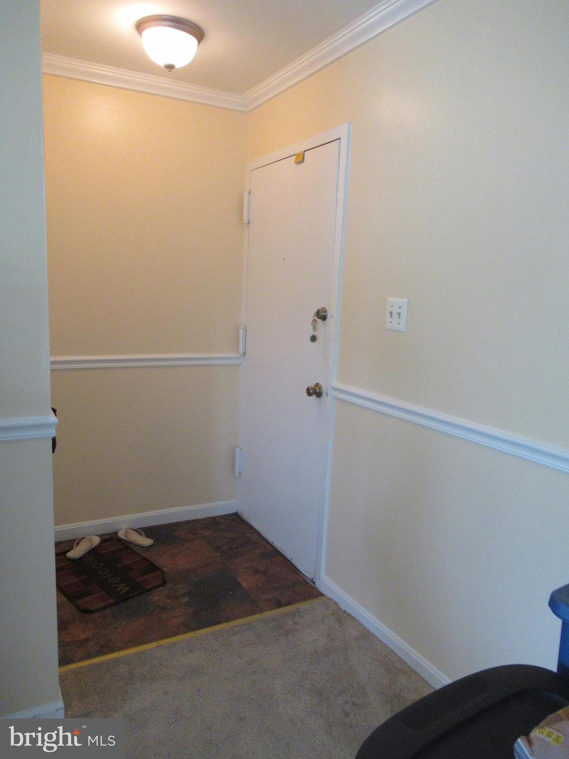 3812 Bel Pre Road, Unit 9 Silver Spring, MD 20906 - Photo 3 of 12 Foyer w/closet. Crown molding & chair railing.