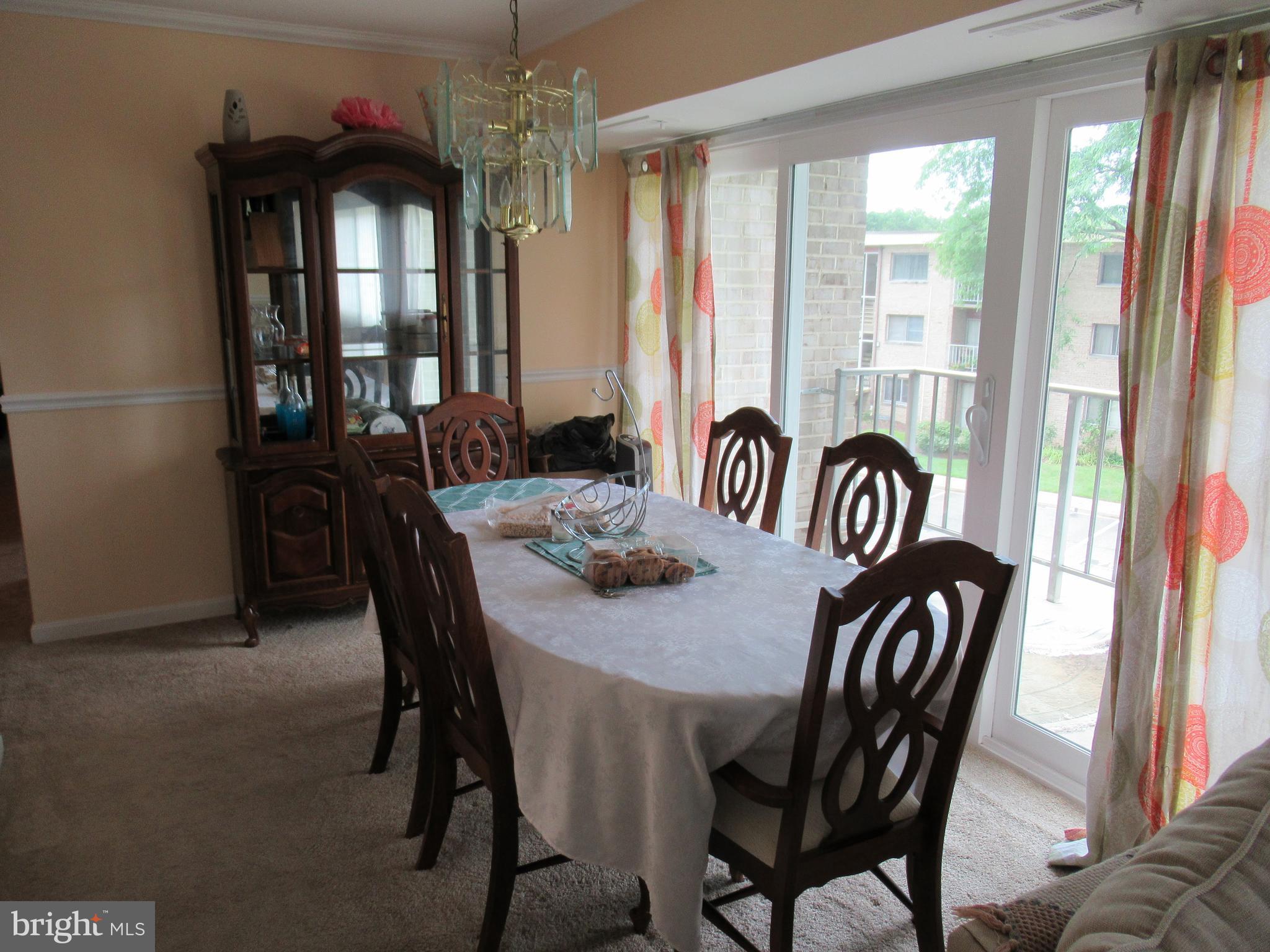 3812 Bel Pre Road, Unit 9 Silver Spring, MD 20906 - Photo 5 of 12 Dine Rm. Vinyl slider to balcony. Crown molding