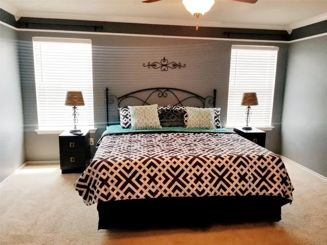 a bedroom with a bed and a chandelier