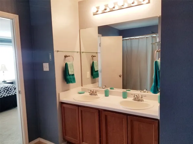 a bathroom with a toilet and a shower curtain