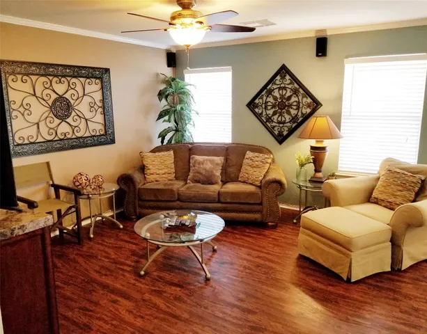 a living room with furniture a table and a potted plant