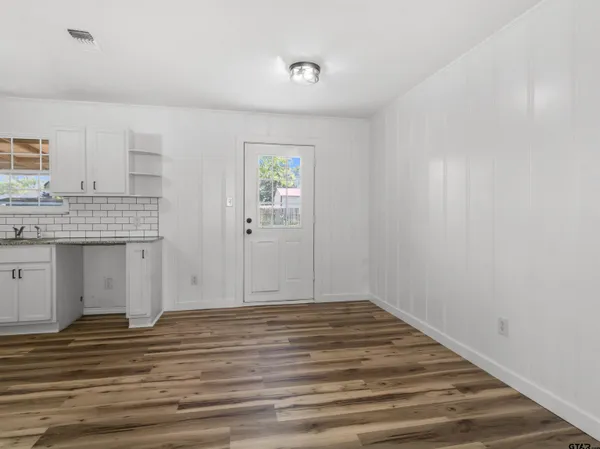 a view of a kitchen cabinets and wooden floor