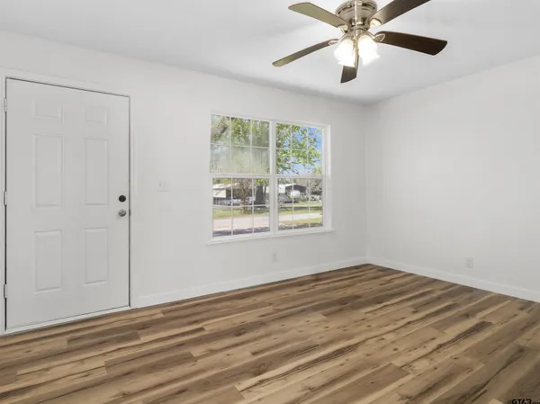 wooden floor in an empty room with a window