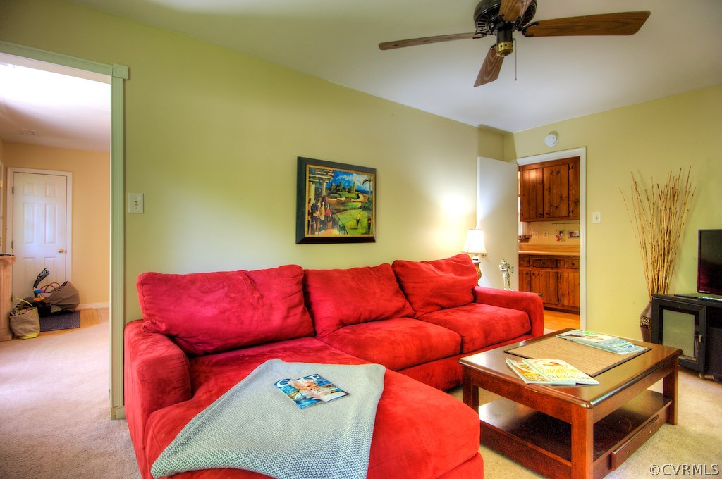 8430 Boones Trail Road Chesterfield, VA 23832 - Photo 11 of 24 a blue couch sitting in a living room next to a window