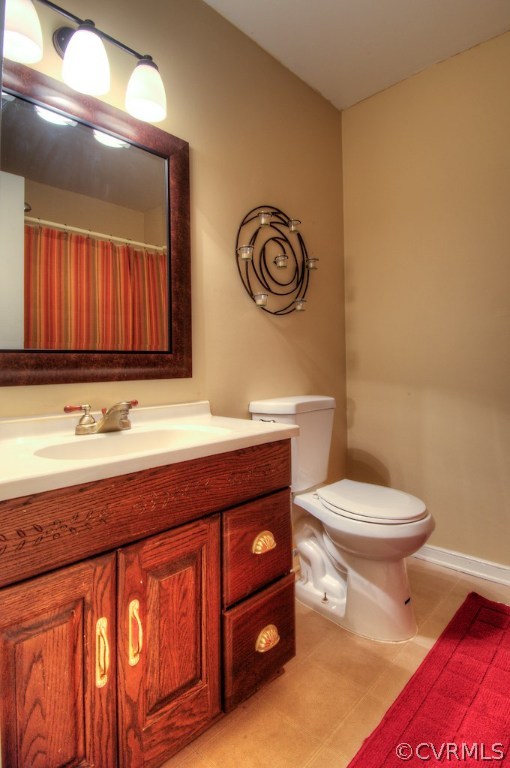8430 Boones Trail Road Chesterfield, VA 23832 - Photo 18 of 24 a bathroom with a toilet a sink and mirror