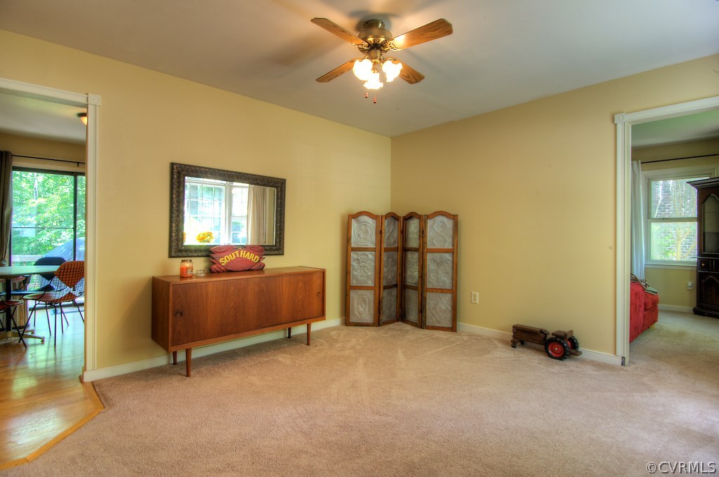 8430 Boones Trail Road Chesterfield, VA 23832 - Photo 4 of 24 a spacious bedroom with a bed and a chandelier