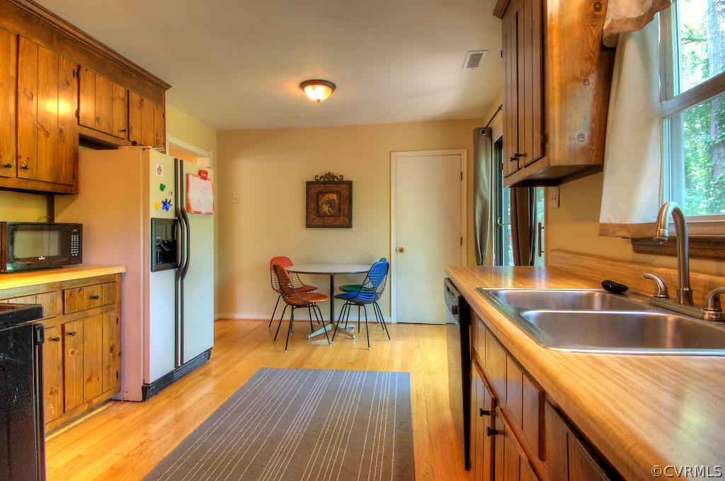8430 Boones Trail Road Chesterfield, VA 23832 - Photo 6 of 24 a kitchen that has a sink and a wooden floor