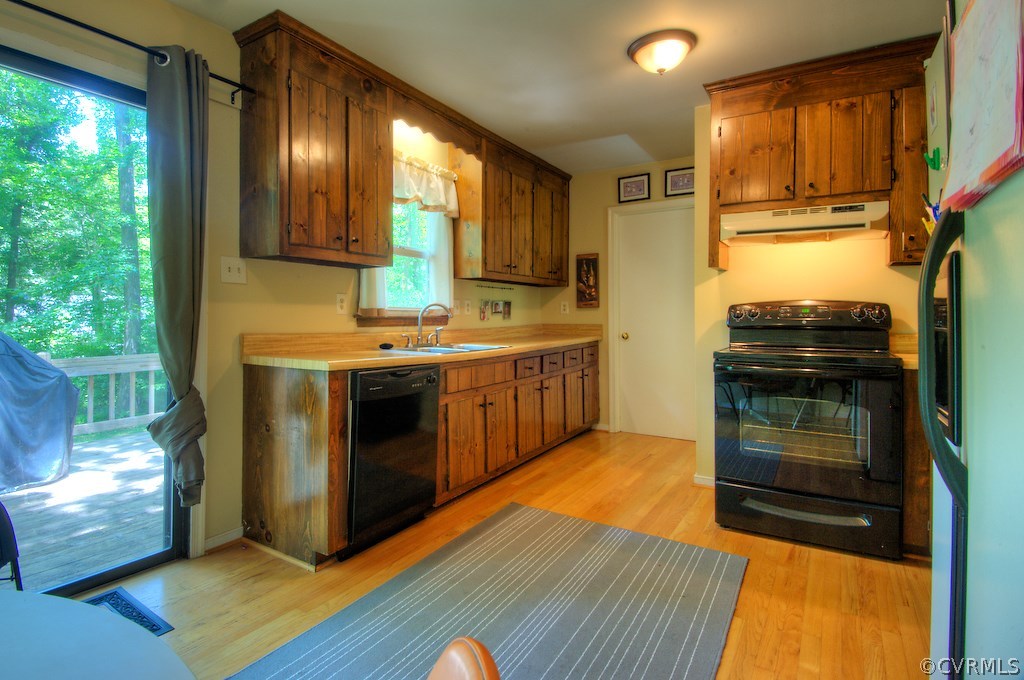 8430 Boones Trail Road Chesterfield, VA 23832 - Photo 7 of 24 a kitchen with stainless steel appliances granite countertop a stove a sink and a microwave